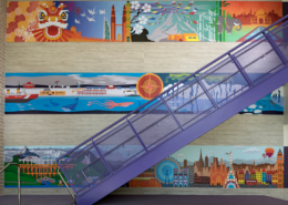 Pomeroy Elementary School wall murals near staircase featuring bright vivid cultural graphics