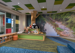 Thornton Elementary School Wall mural in childens library featuring a stream